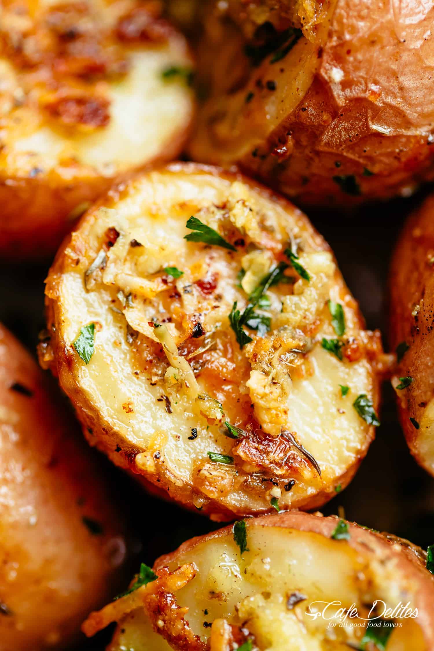 Herbs, garlic, and parmesan cheese are roasted together to make the best Crispy Browned Butter Parmesan Roasted Potatoes! A delicious side dish with so much flavour, these potatoes go with ANYTHING! | cafedelites.com