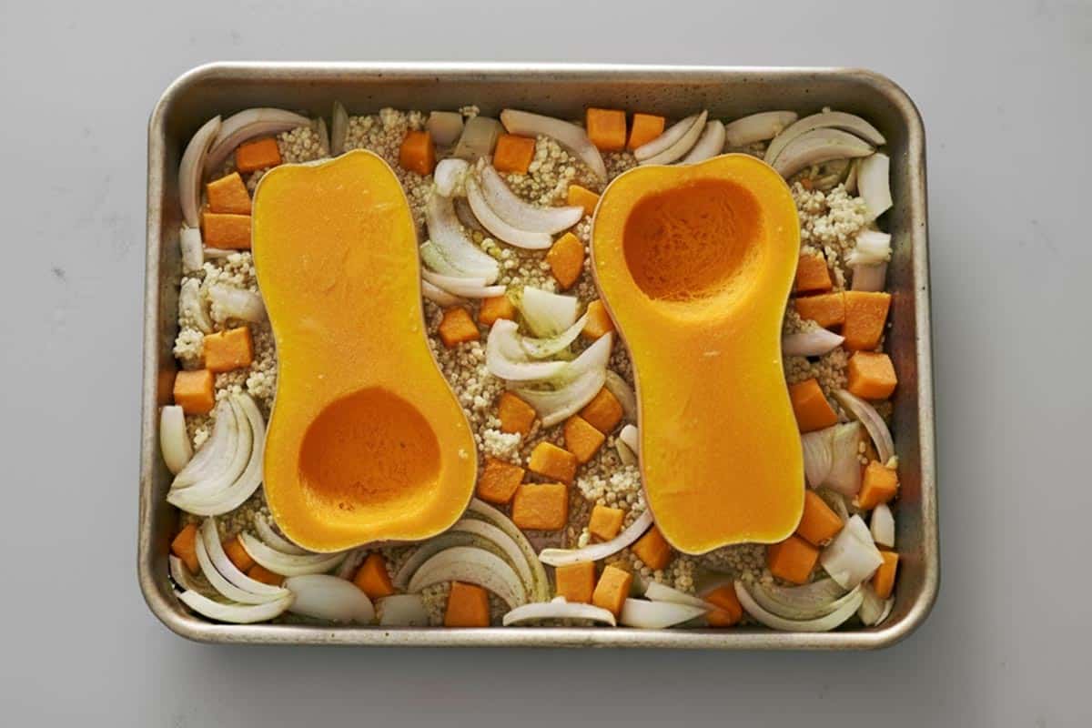 Squash halves on the pan cut side up, skin side down on a tray and arranged the onion wedges, garlic, and diced carrots around the squash in a single layer.