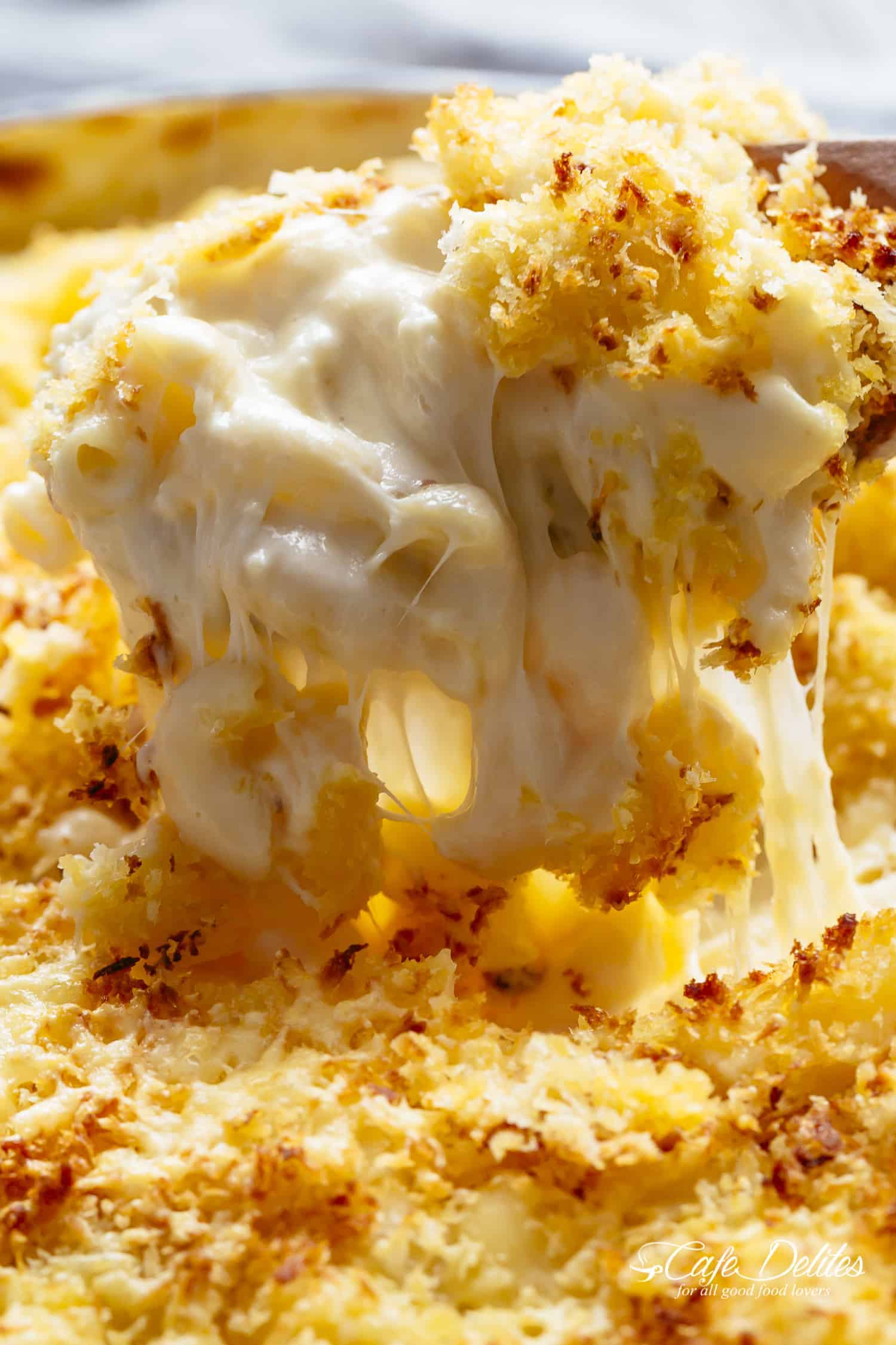 Mac And Cheese is better than the original! A creamy garlic parmesan cheese sauce coats your macaroni, topped with parmesan fried bread crumbs, while saving some calories! | https://cafedelites.com