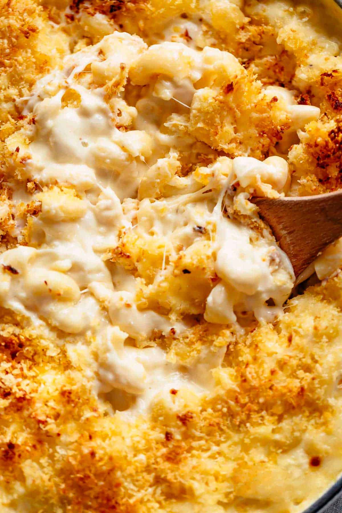 Mac And Cheese is better than the original! A creamy garlic parmesan cheese sauce coats your macaroni, topped with parmesan fried bread crumbs, while saving some calories! | https://cafedelites.com