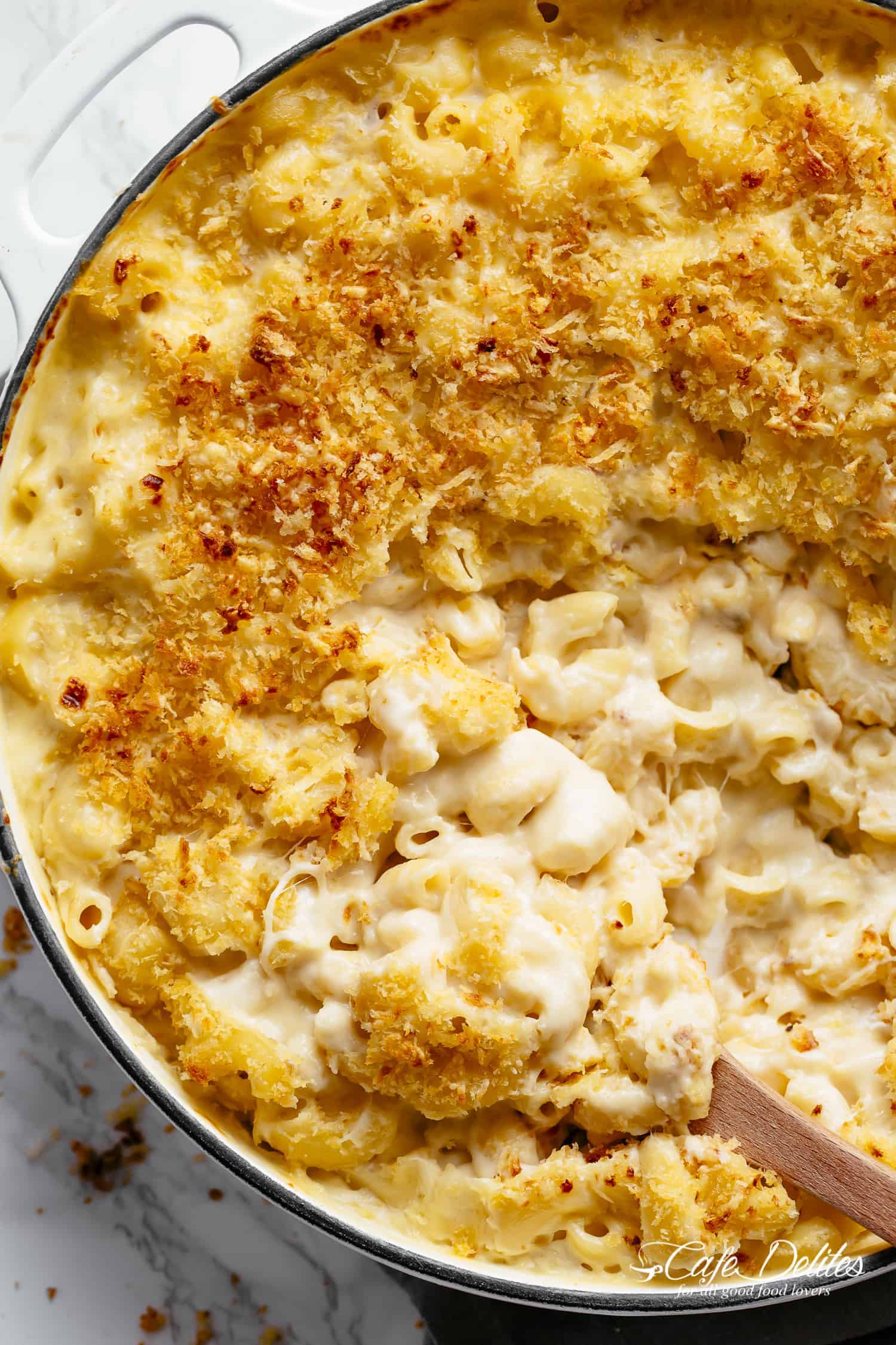 Mac And Cheese is better than the original! A creamy garlic parmesan cheese sauce coats your macaroni, topped with parmesan fried bread crumbs, while saving some calories! | https://cafedelites.com