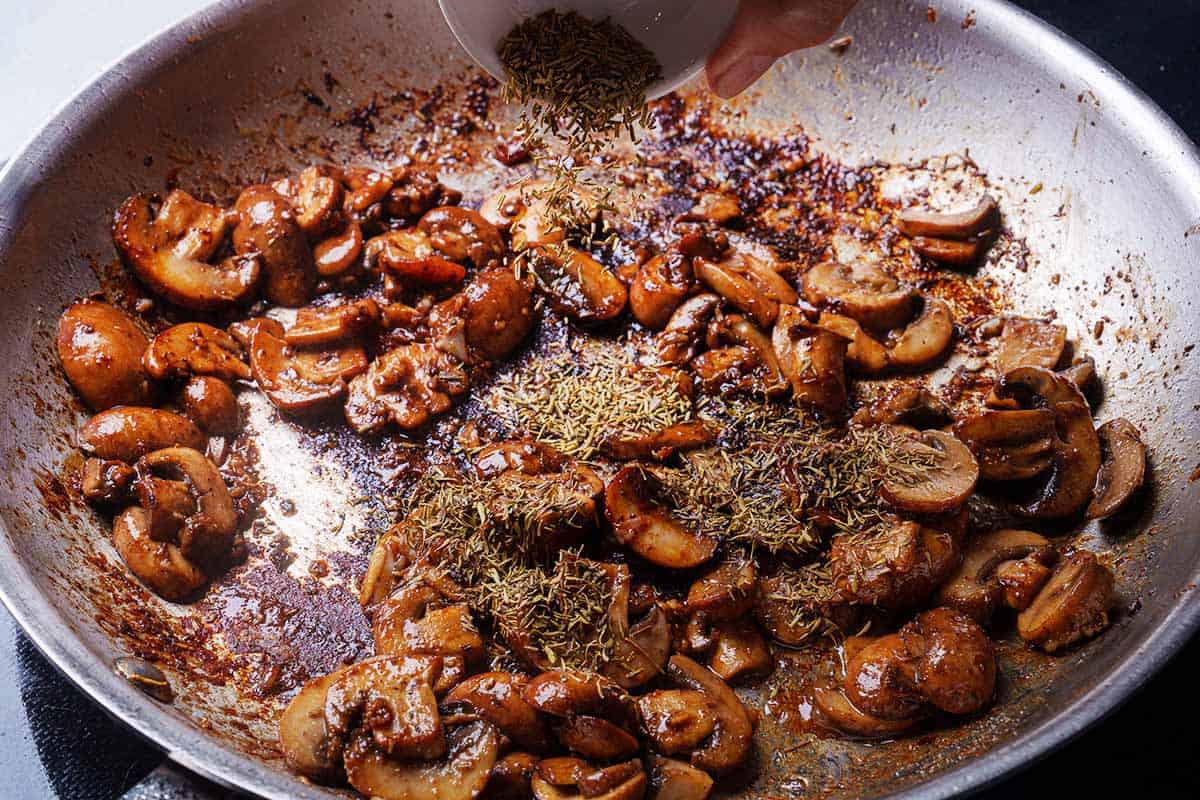 Mushrooms are tossed in a pan and sauted