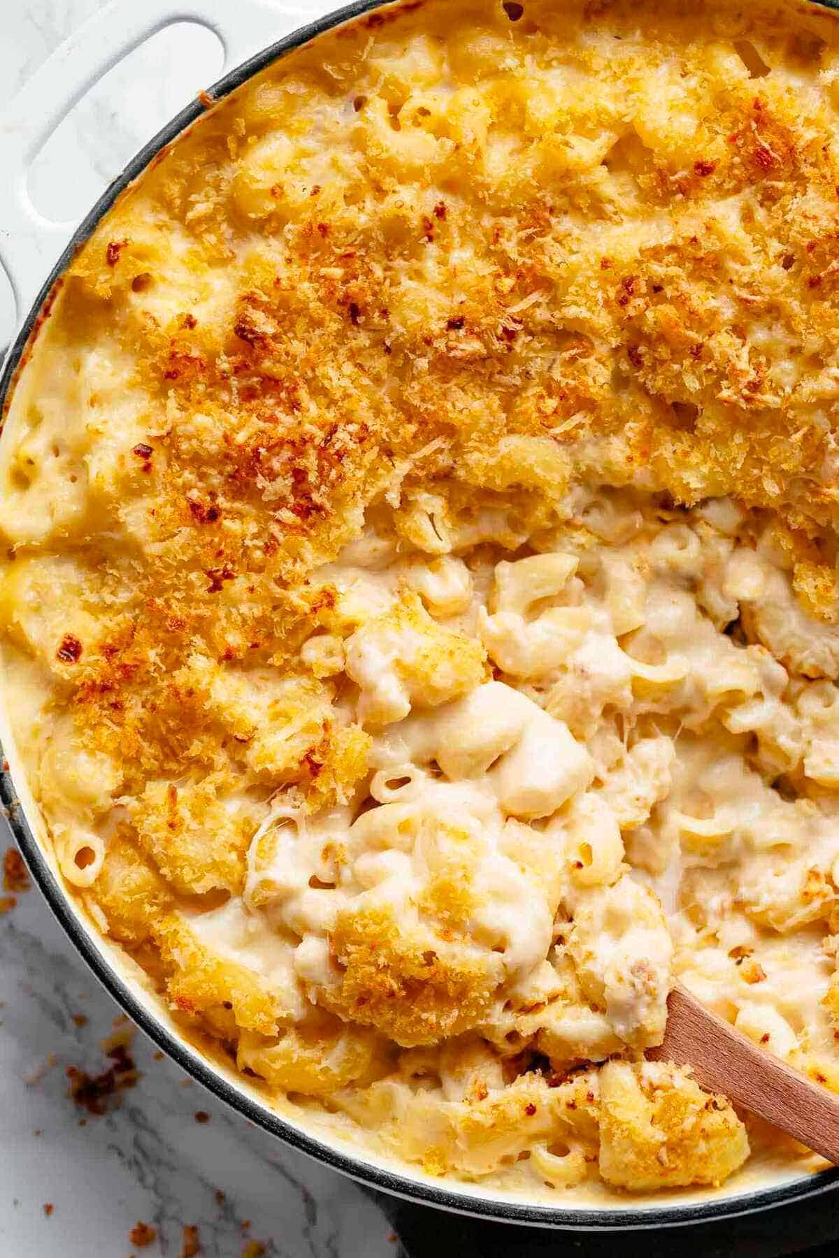 Mac And Cheese is better than the original! A creamy garlic parmesan cheese sauce coats your macaroni, topped with parmesan fried bread crumbs, while saving some calories! | https://cafedelites.com