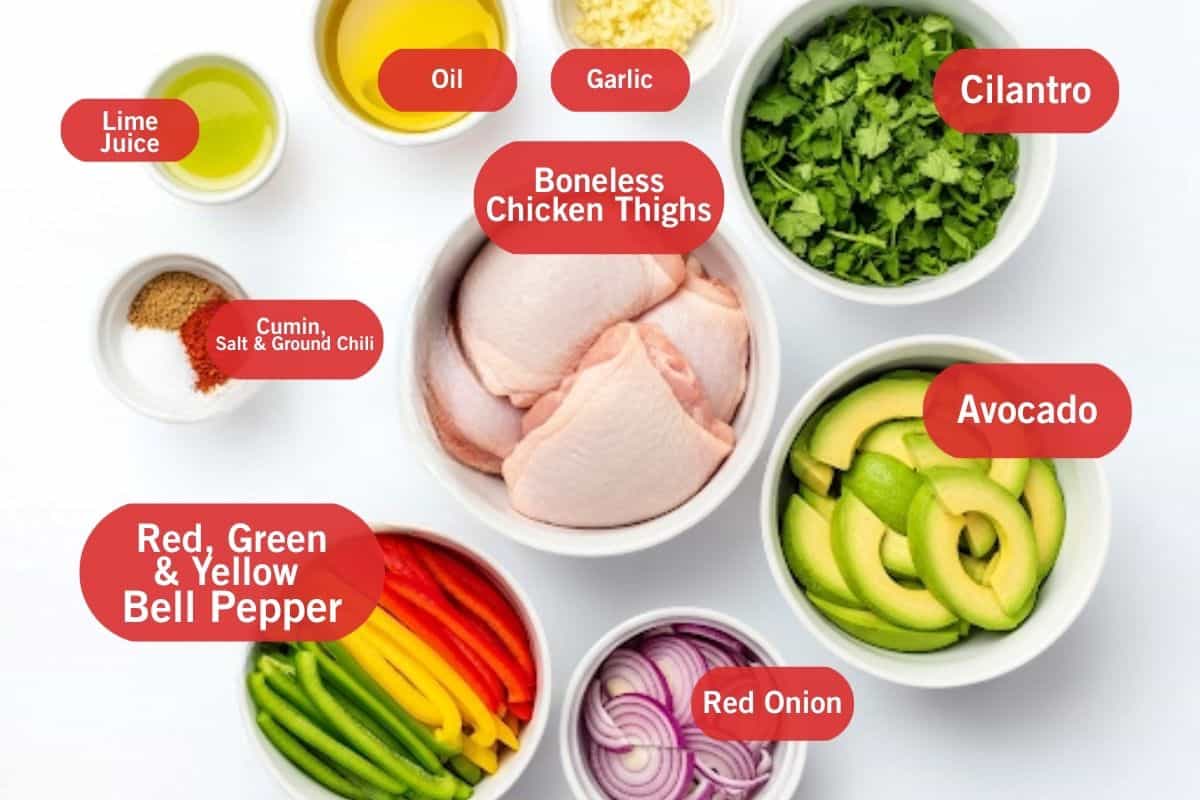 Flat lay shot of lime juice, oil, garlic, cilantro, boneless chicken thighs, cumin, salt, ground chili, avocado, red, green and yellow bell peppers and red onion