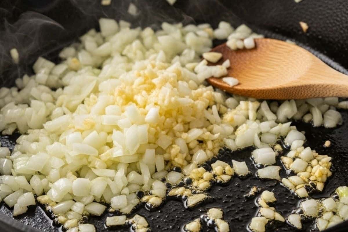 Sauté onion until translucent, then stir in garlic and cook for 1 minute until fragrant.