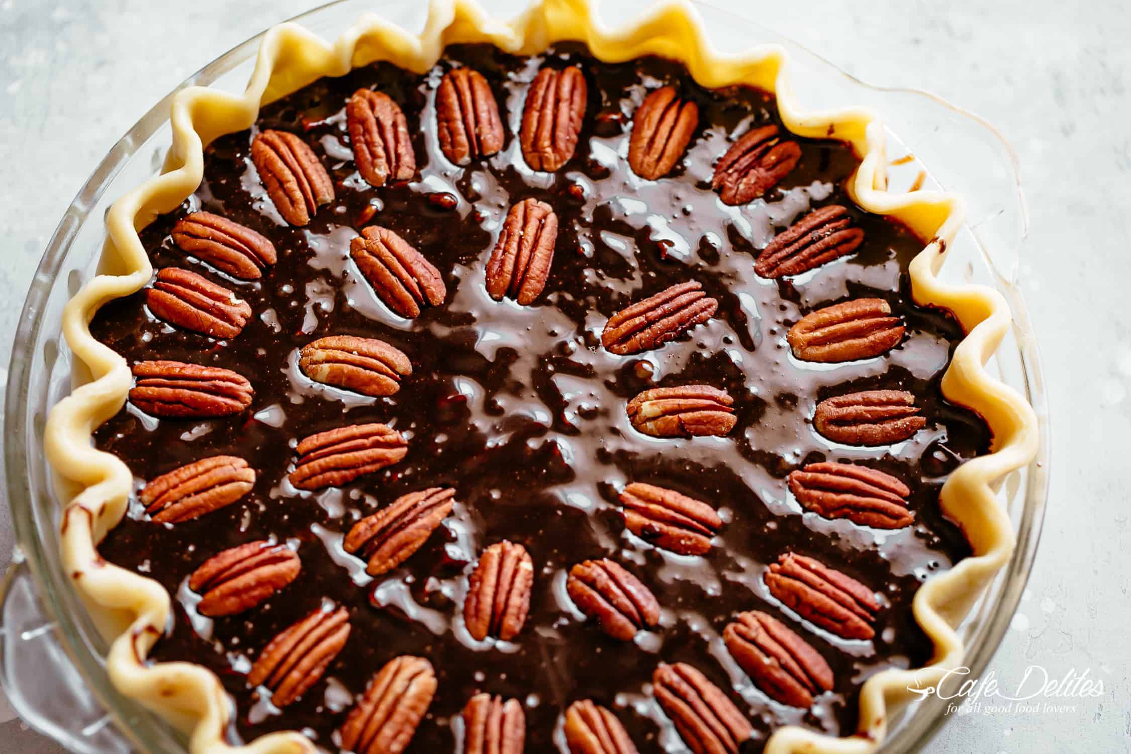 A shot of a pecan pie filled before going into an oven.