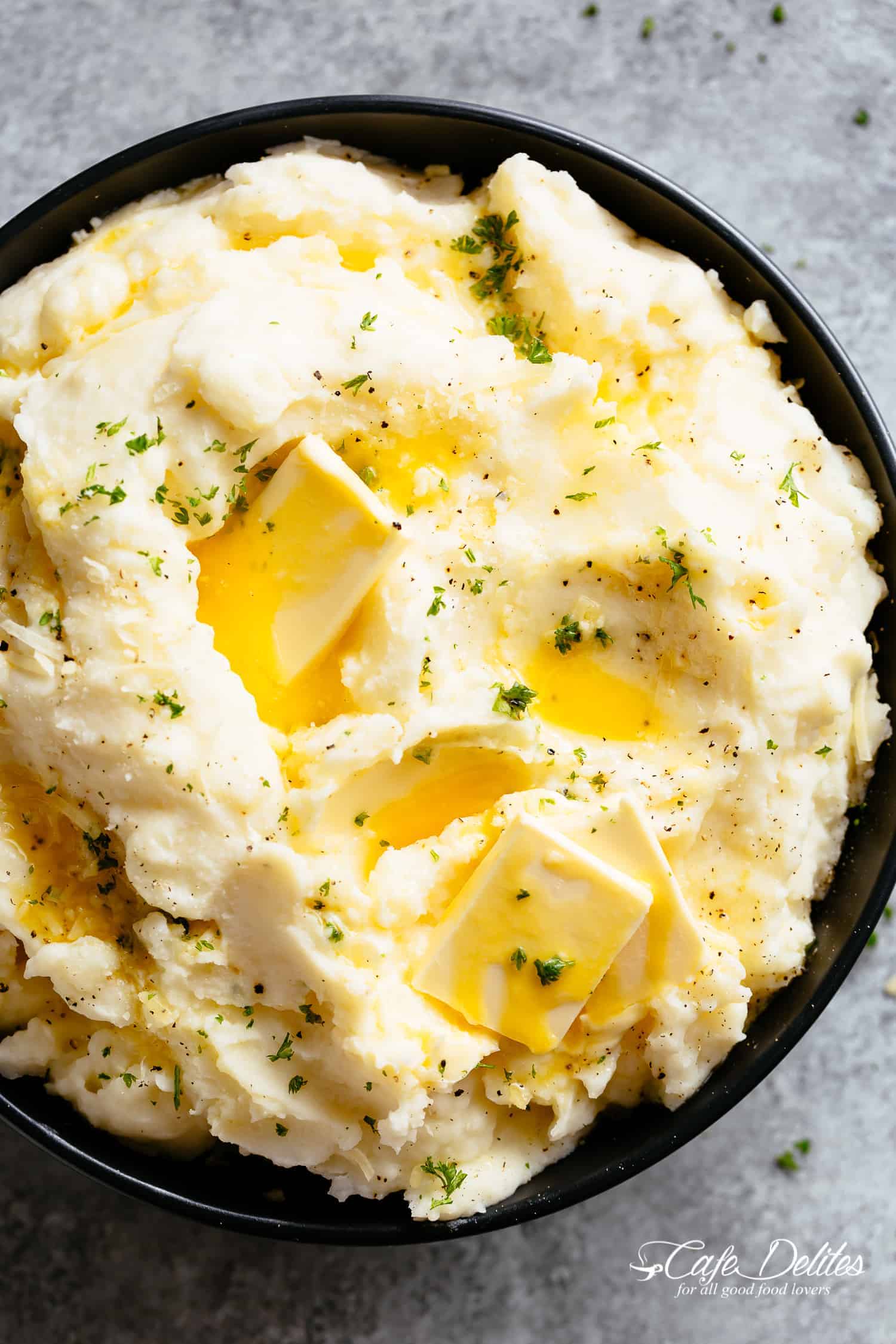 Mashed potatoes in a bowl with melted butter