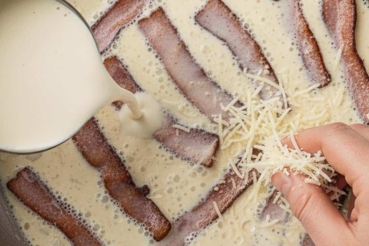 Pouring the half and half and parmesan cheese in the pan.