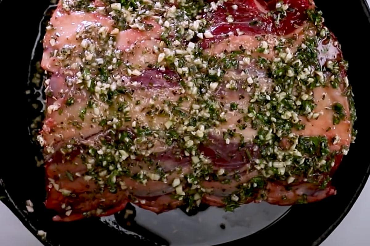 Coated roast in a pan.