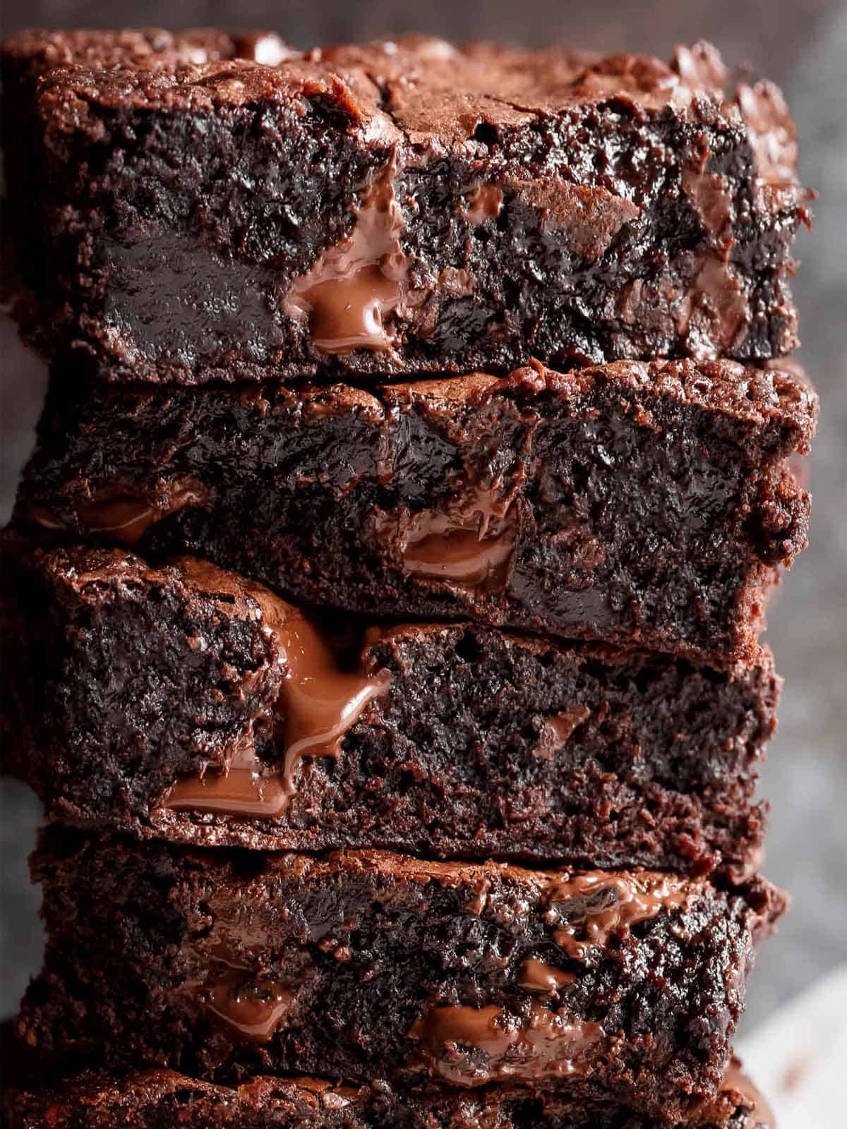 Image of fudgy, buttery brownies stacked on top of each other.