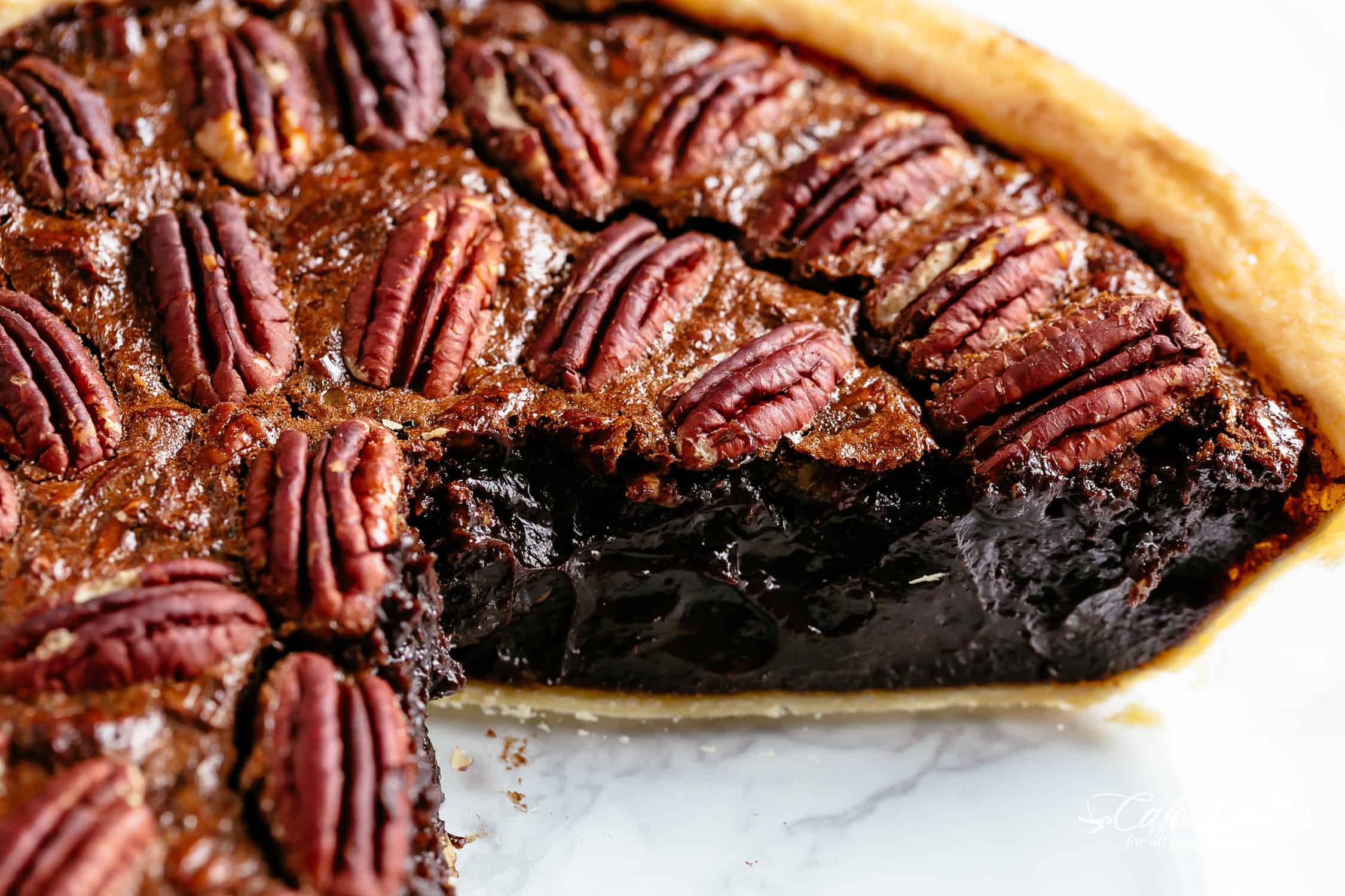 Close up of a completed pie with a golden crust, with a slice cut out of it. 