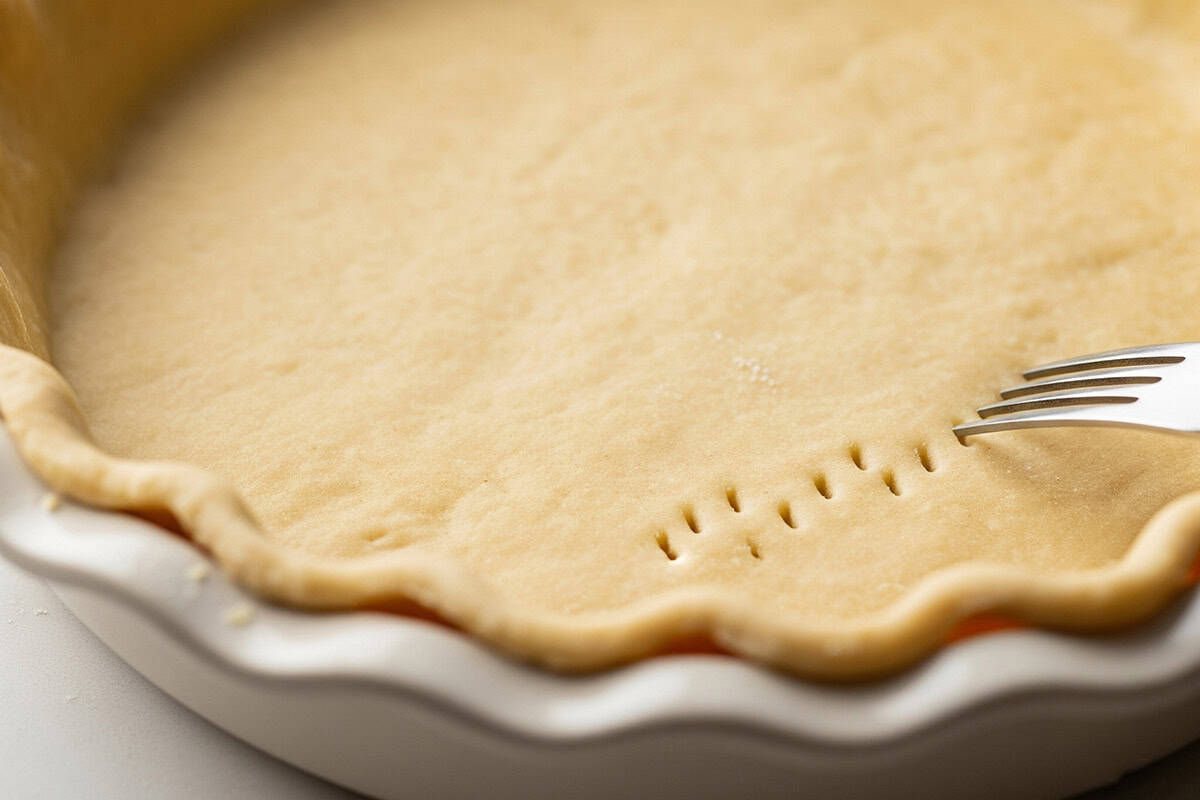 Pie crust with tiny holes using fork.
