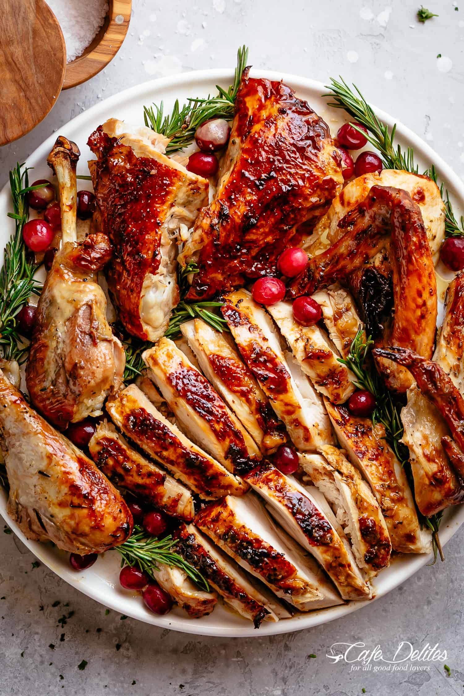 The recipe for roast turkey with herb butter and garlic is succulent and tender inside with a golden and buttery skin and lots of flavor! | cafedelites.com