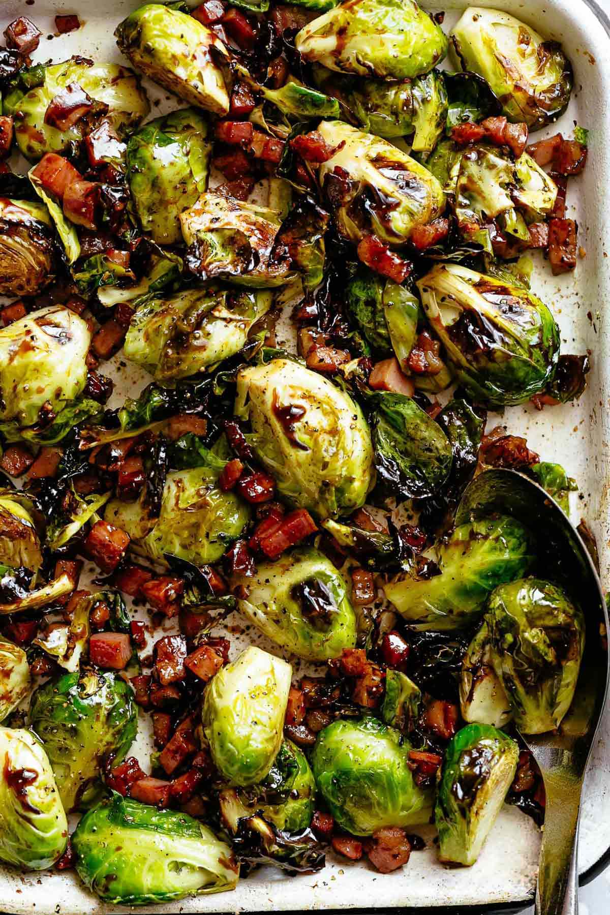Garlic Roasted Brussels Sprouts with crispy bacon or pancetta, finished off with a balsamic reduction.