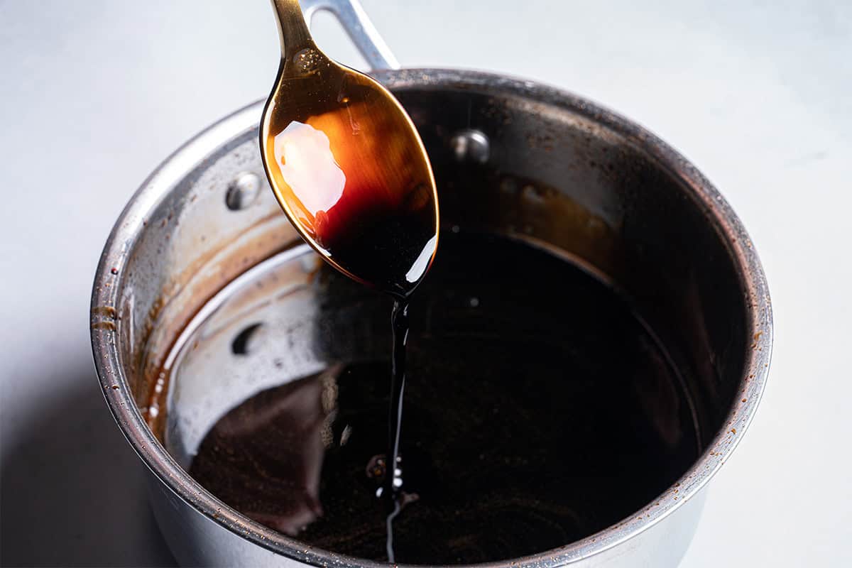balsamic glaze being dripped on a spoon
