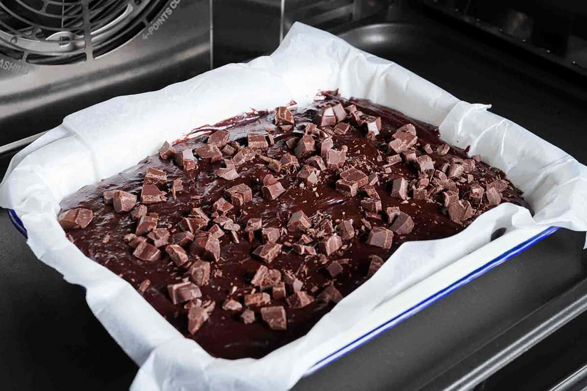 Chocolate mixture poured into the baking tray, being put into the oven.