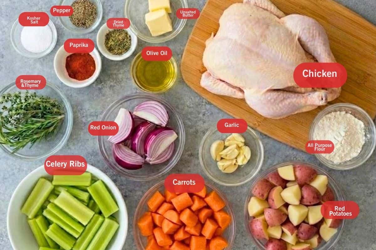 Flat lay photo of ingredient shot for slow cooker whole chicken: kosher salt, pepper, paprika, dried thyme, unsalted butter, chicken, all purpose flour, garlic, rosemary and thyme, celery ribs, red onions, carrots, red potatoes, all purpose flour