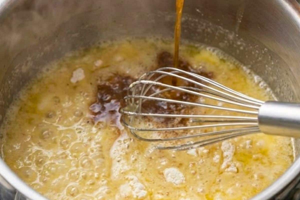 Melt butter in a pan, whisk in flour to form a pale roux, then gradually whisk in 1 cup defatted drippings