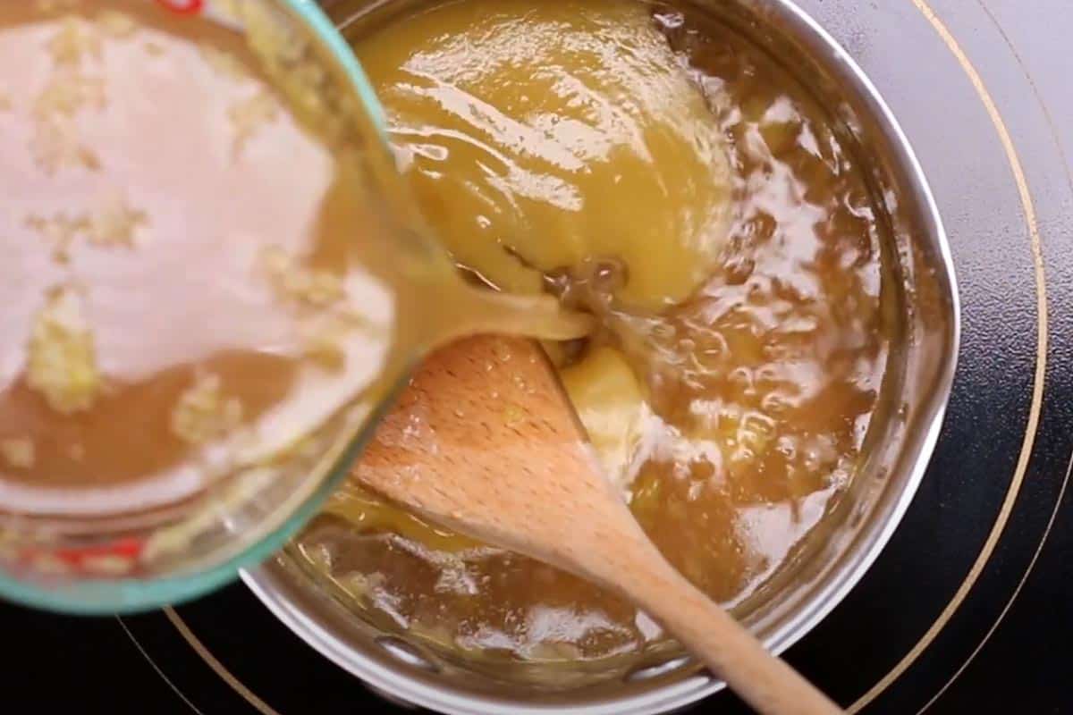 Pouring the pan juices in the small pot with mixed butter and flour.