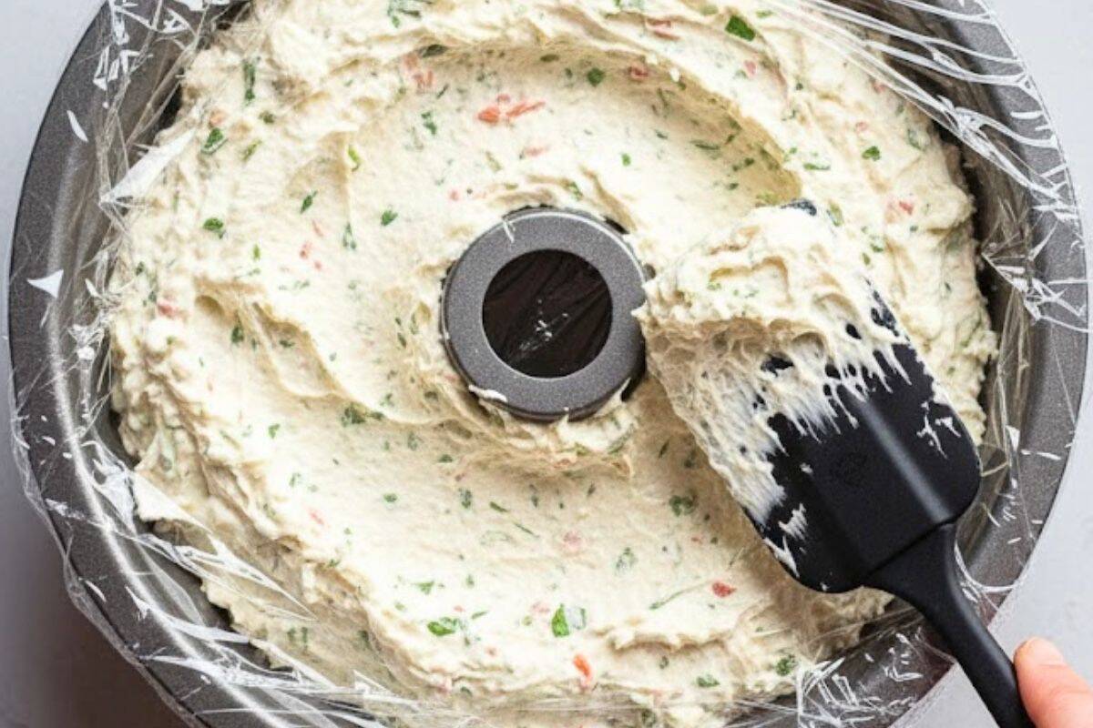 Scoop cheese mixture into the Bundt pan, spreading it evenly and pressing down to remove any air pockets.