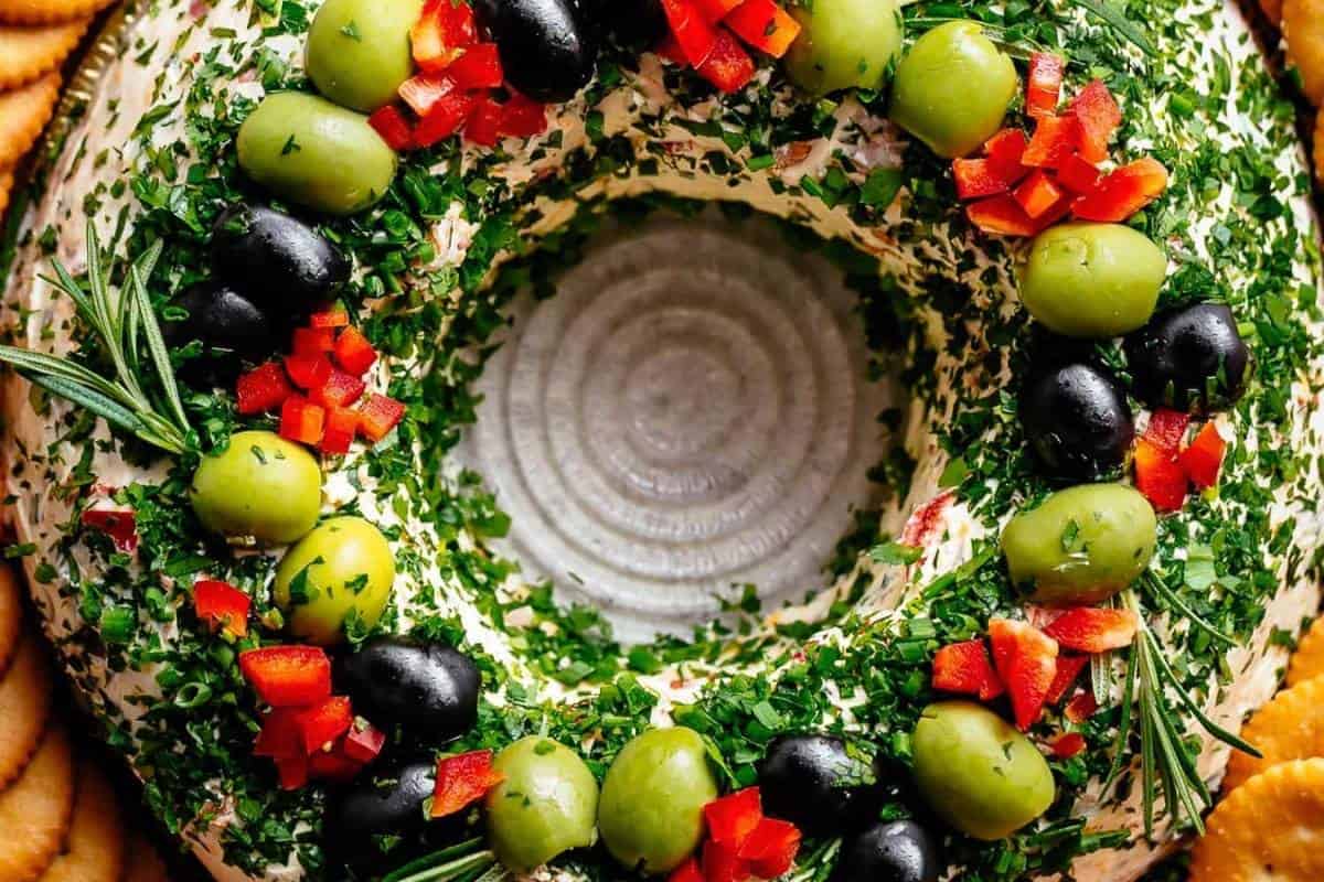 Sprinkle parsley, chives, and green onions on top. Add olives, bell pepper, and rosemary