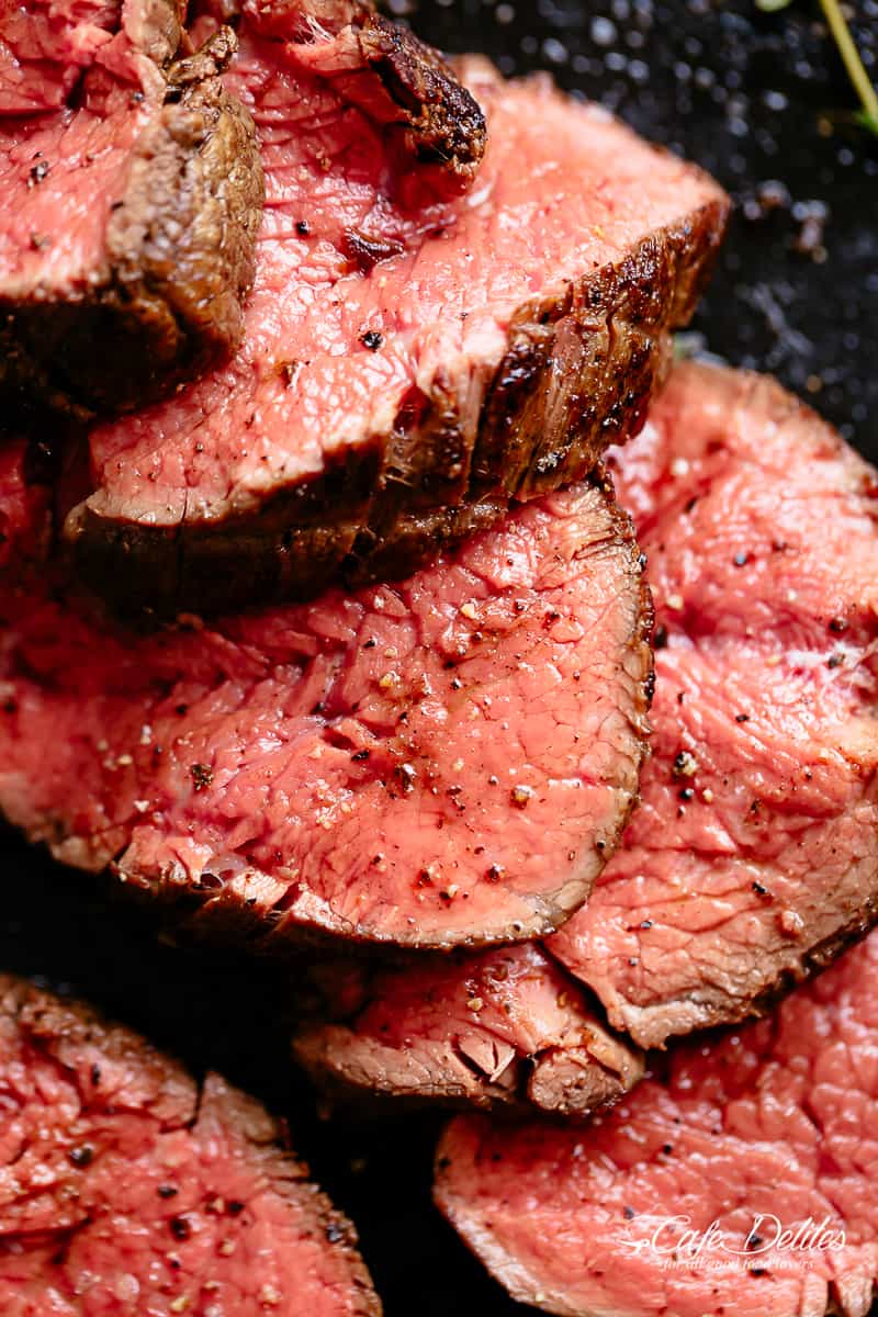 The best, juicy roast Beef Tenderloin slathered with garlic butter that melts in your mouth with every bite! Even better when served with a rich and rustic, easy to make red wine sauce (or jus) | cafedelites.com