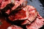 The best, juicy roast Beef Tenderloin slathered with garlic butter that melts in your mouth with every bite! Even better when served with a rich and rustic, easy to make red wine sauce (or jus) | cafedelites.com