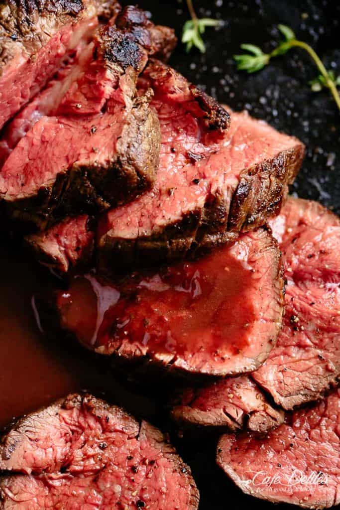 The best, juicy roast Beef Tenderloin slathered with garlic butter that melts in your mouth with every bite! Even better when served with a rich and rustic, easy to make red wine sauce (or jus) | cafedelites.com