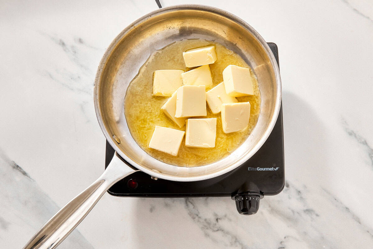 Unsalted butter melting in a small saucepan.