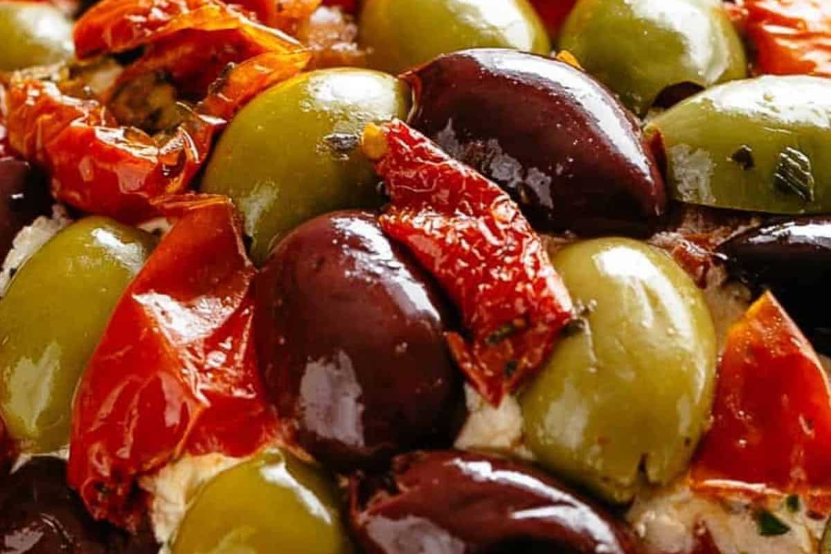 Lightly press the olives and tomatoes into the cheese ball until evenly coated. - 7