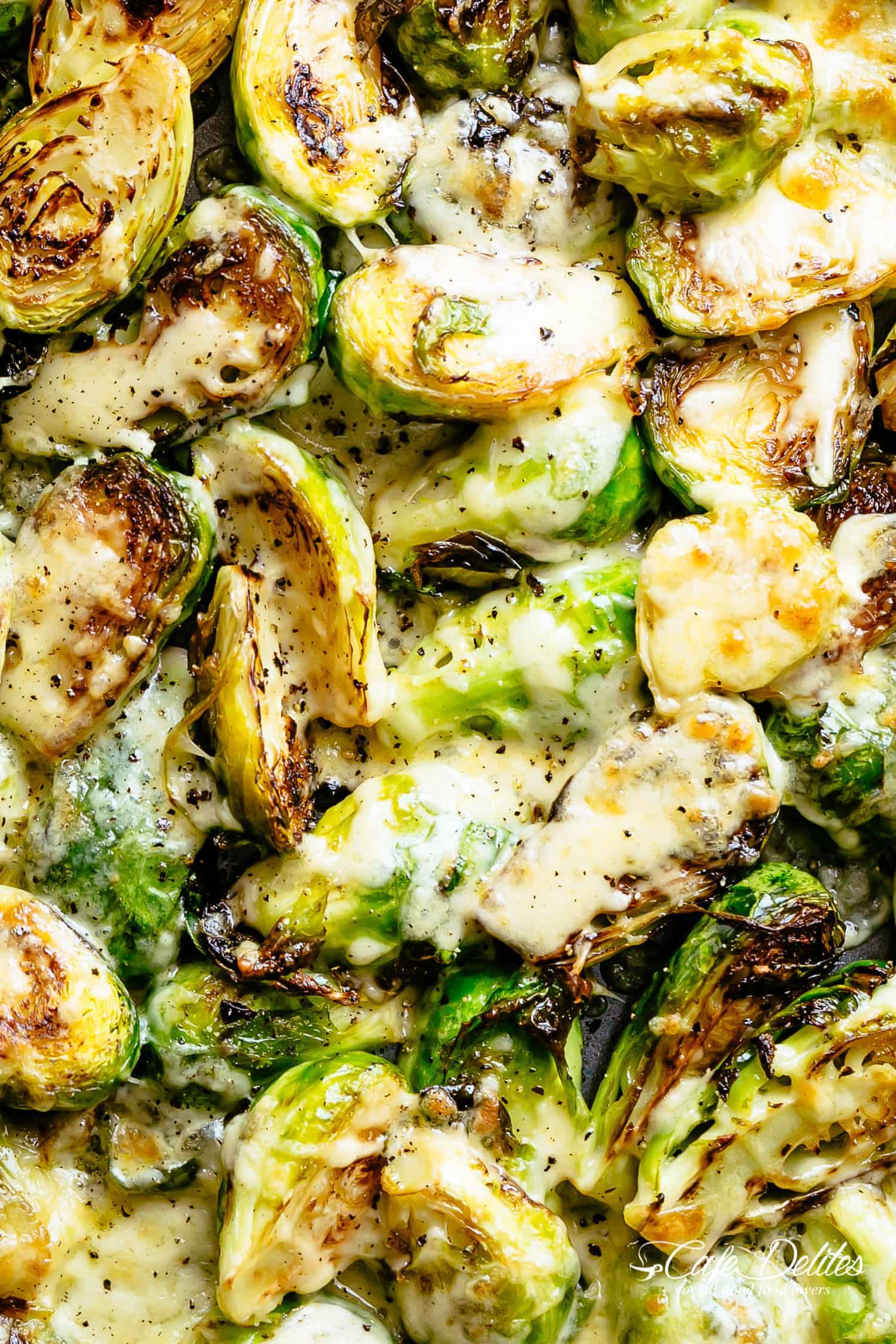 Cheesy Garlic Roasted Brussels Sprouts Recipe caramelized and topped with melted mozzarella cheese! | cafedelites.com