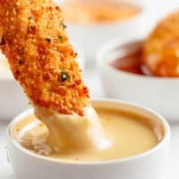 Chicken Tenders dipped in honey mustard sauce.