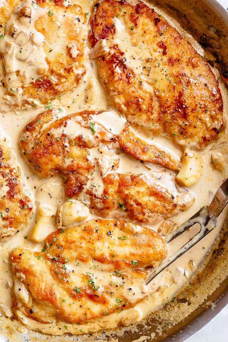 Chicken breast in a skillet with sauce