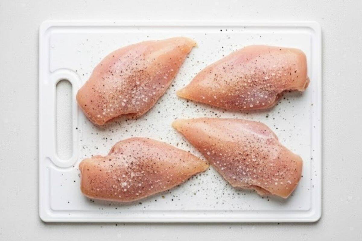 Season the sliced chicken breasts with salt, pepper and garlic powder.
