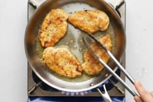 Heat oil and butter in a large skillet over medium heat and add the chicken. Fry for a few minutes on each side until they’re light golden brown,
