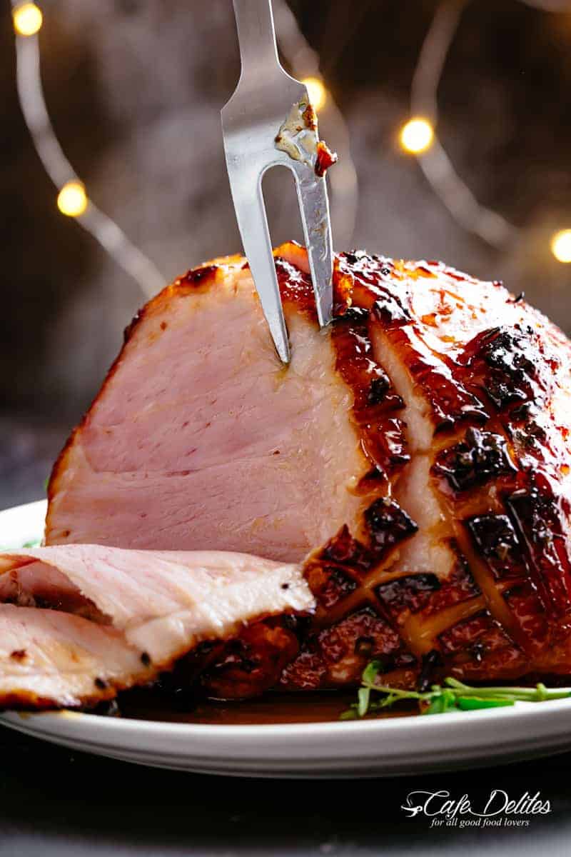 Honey Baked Ham basted with a hint of pineapple juice and a buttery sticky glaze! Let the holidays begin with a slice or two of Honey Baked Ham! Juicy and succulent on the inside with crispy, charred, sticky edges. The perfect ham for your Christmas dinner table! | cafedelites.com