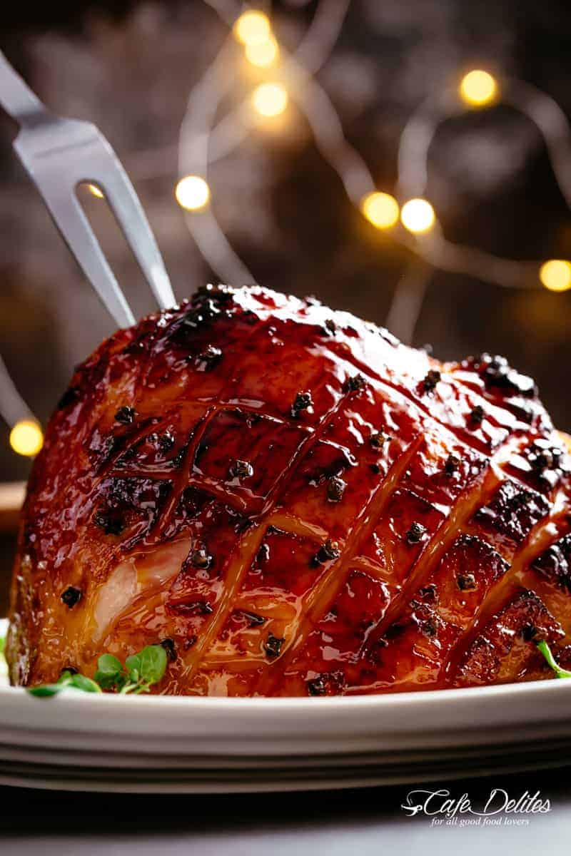 Honey Baked Ham basted with a hint of pineapple juice and a buttery sticky glaze! Let the holidays begin with a slice or two of Honey Baked Ham! Juicy and succulent on the inside with crispy, charred, sticky edges is the perfect ham for your Christmas dinner table! | cafedelites.com
