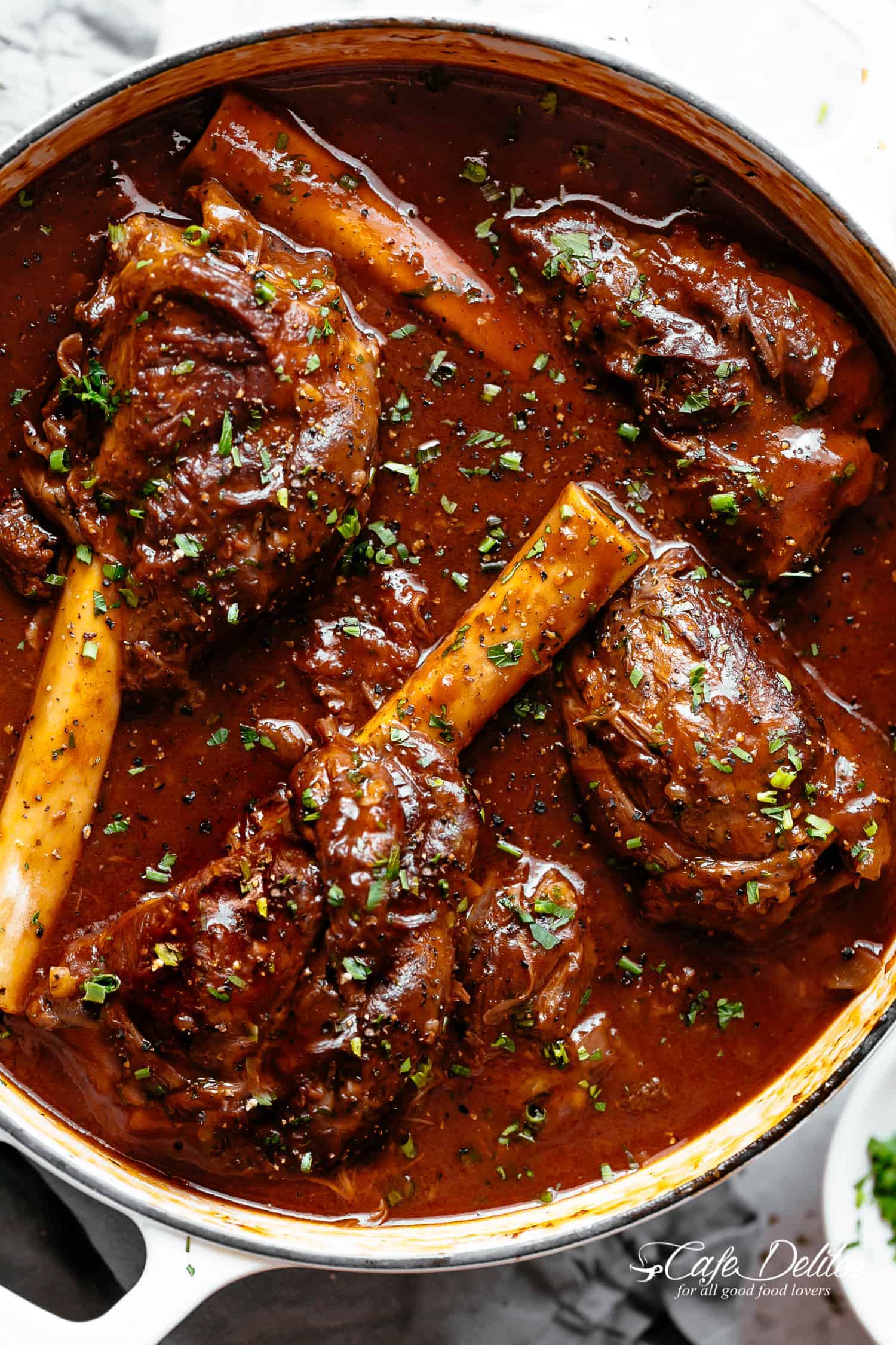Tender, fall off the bone easy braised Lamb Shanks in a luxuriously delicious red wine gravy! Oven, stove top, slow cooker or Instant pot.