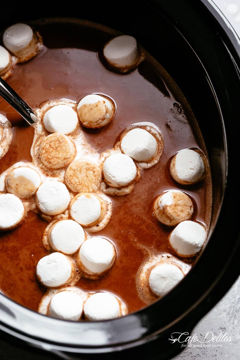 Creamy and decadent hot chocolate made easy in a slow cooker with a secret ingredient to make this the BEST hot chocolate! | cafedelites.com