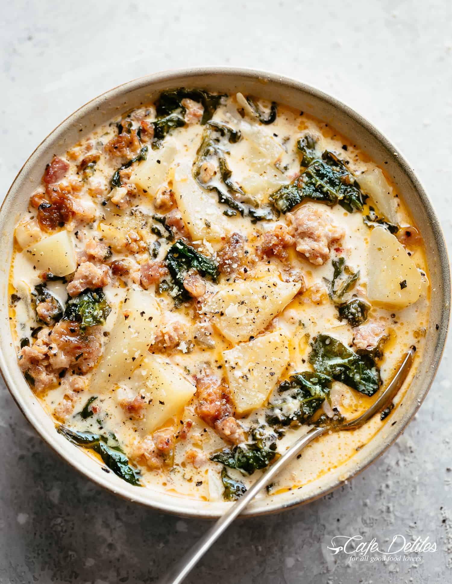 A bowl of Zuppa Toscana with sausage, bacon, kale and potatoes | cafedelites.com