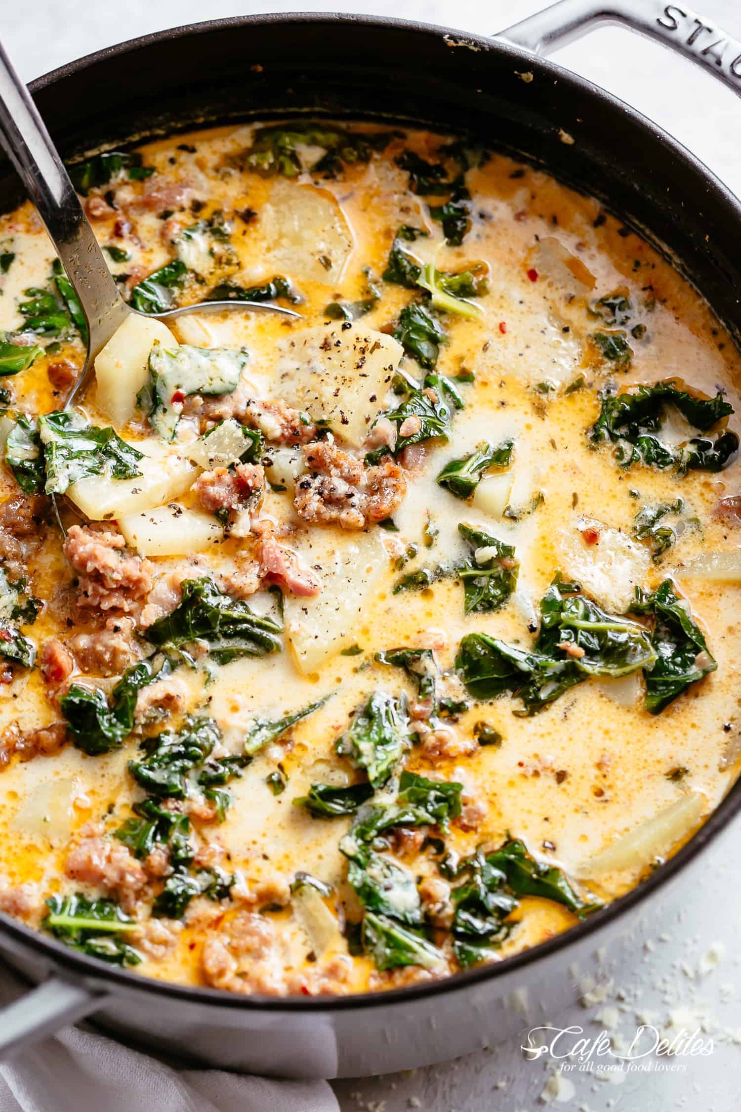 Creamy Zuppa Toscana recipe full of crumbled sausage, crispy bacon and tender potatoes in a creamy broth! One of your favourite Olive Garden soups. | cafedelites.com
