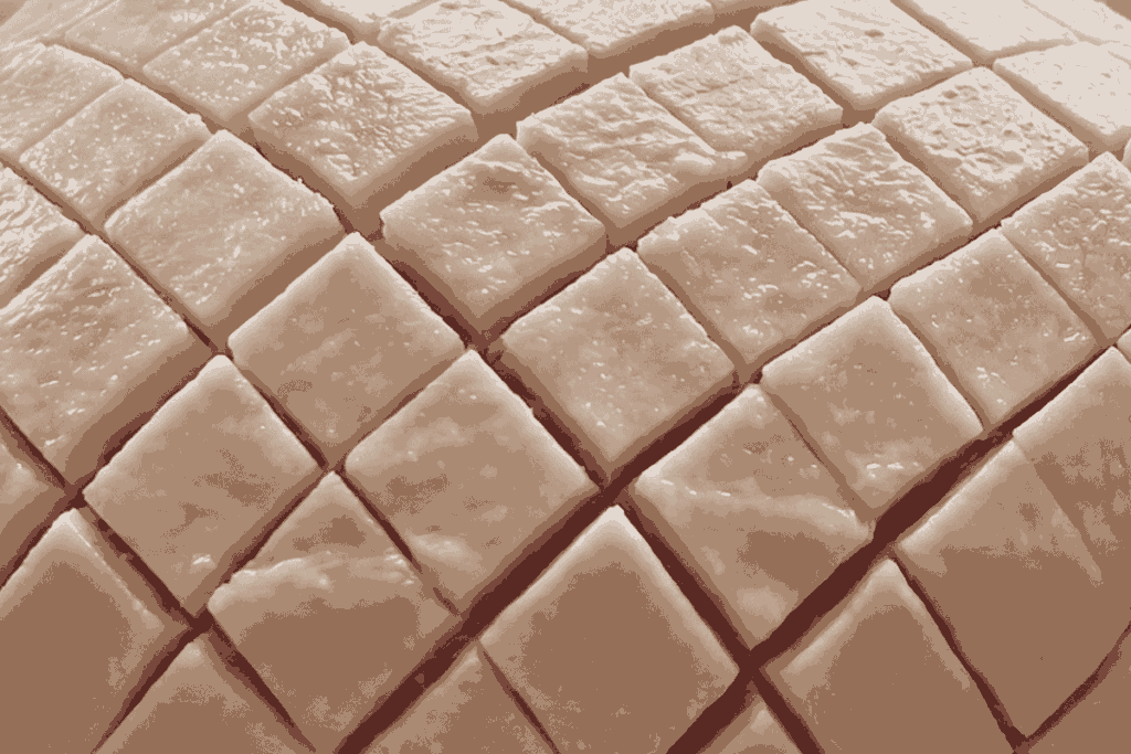 leg ham cut into a diamond shape with the fat showing a bit of pink flesh in the diamond cuts.