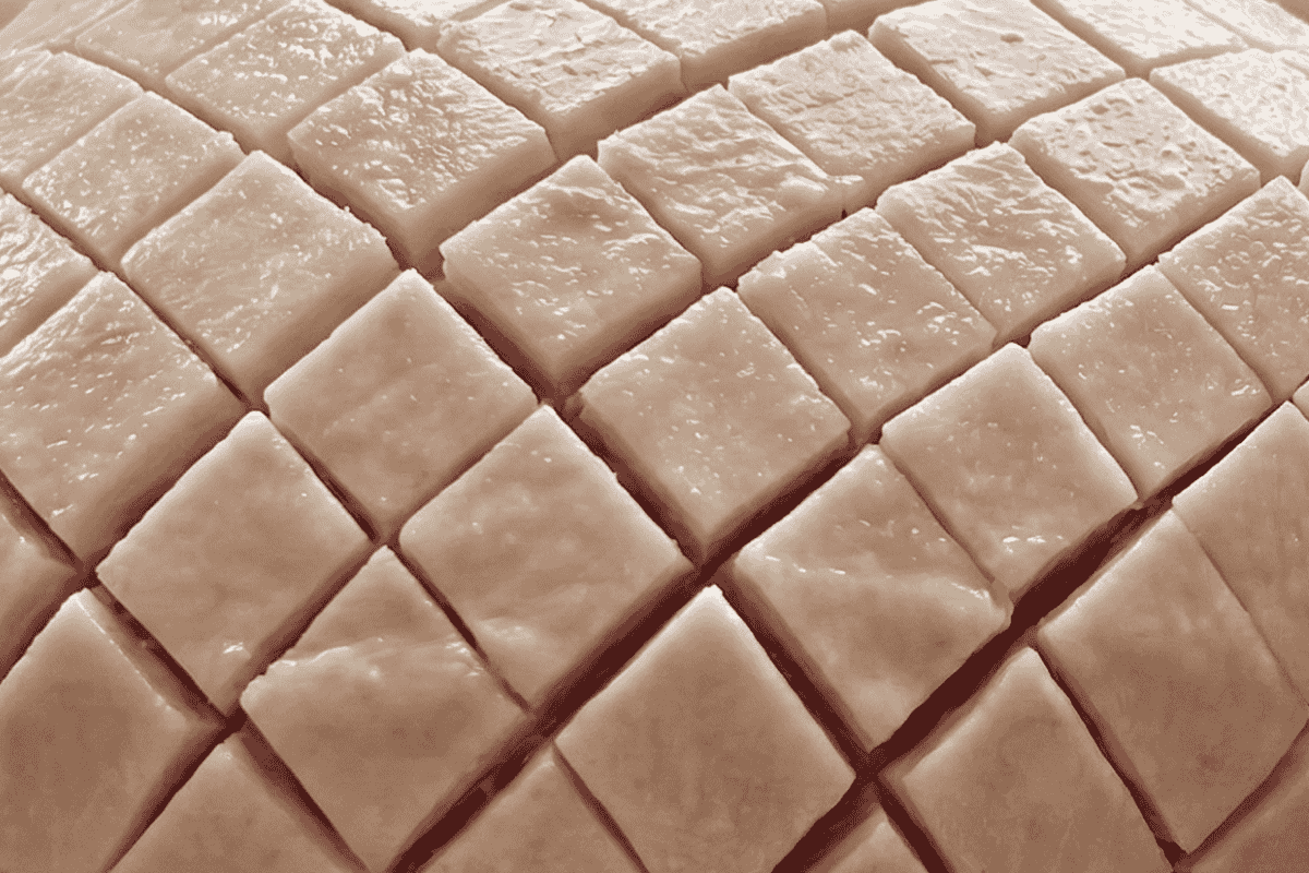 leg ham cut into a diamond shape with the fat showing a bit of pink flesh in the diamond cuts.