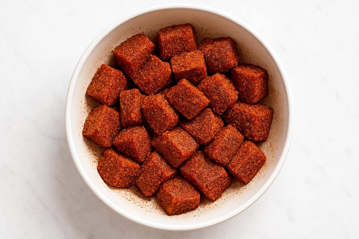 steak in a bowl seasoned with cajun seasoning