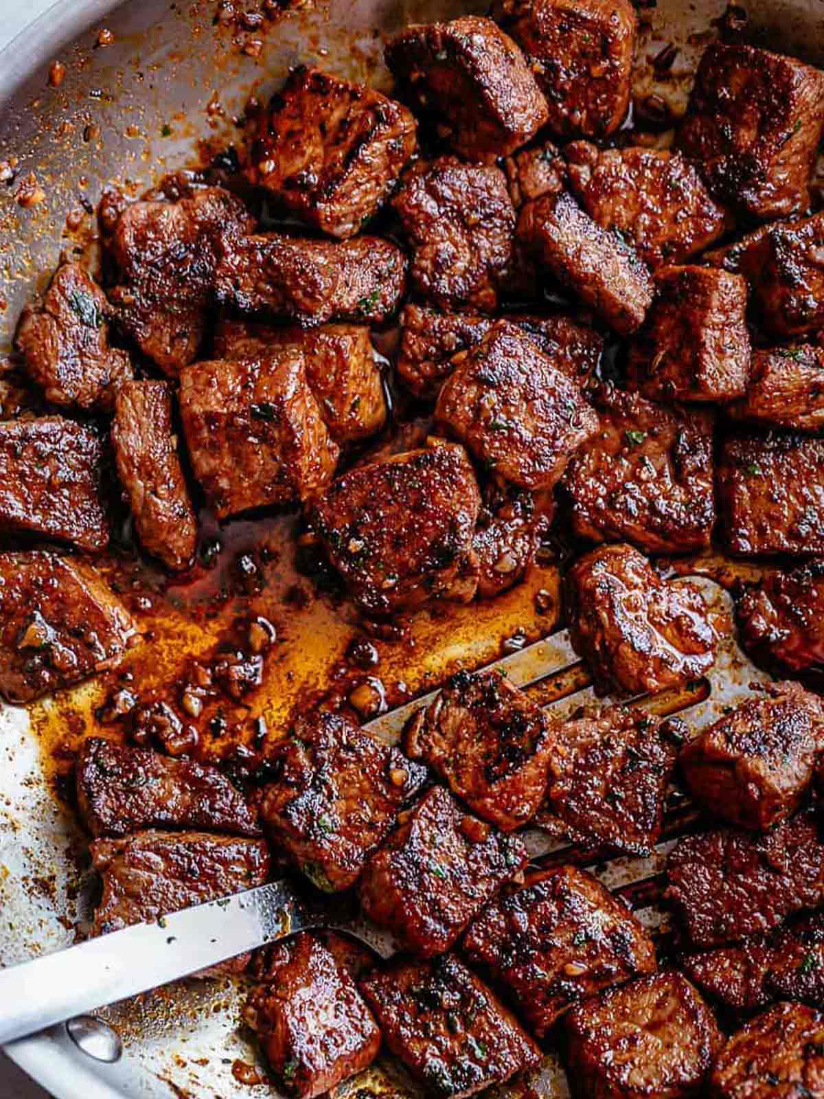 Top view image of Tender pan seared Cajun Butter Steak Bites are full flavored with crispy edges in a pan