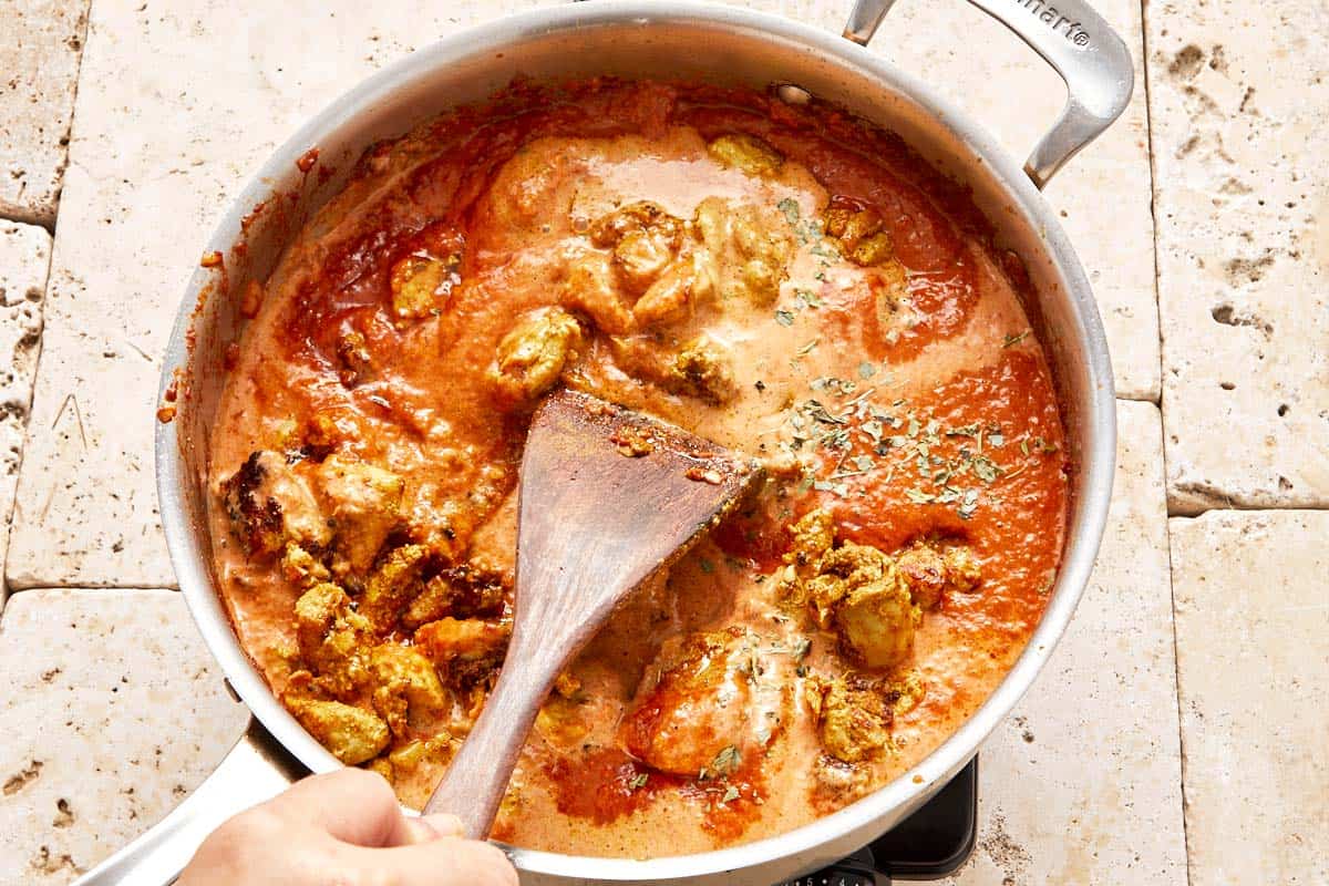 Image of chicken and sauce combined in a pan.