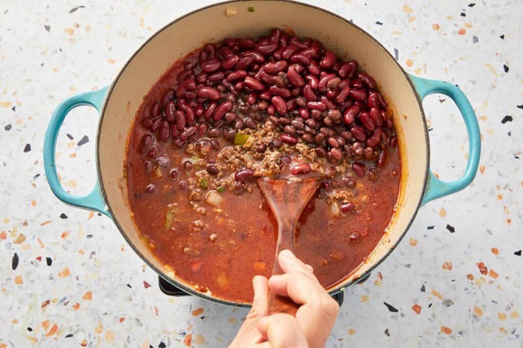 Adding beans to the beef in the pot