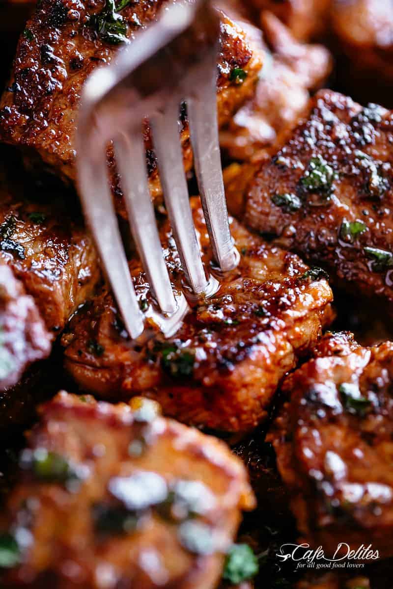 A silver fork pierces a steak bite with crispy edges. | cafedelites.com