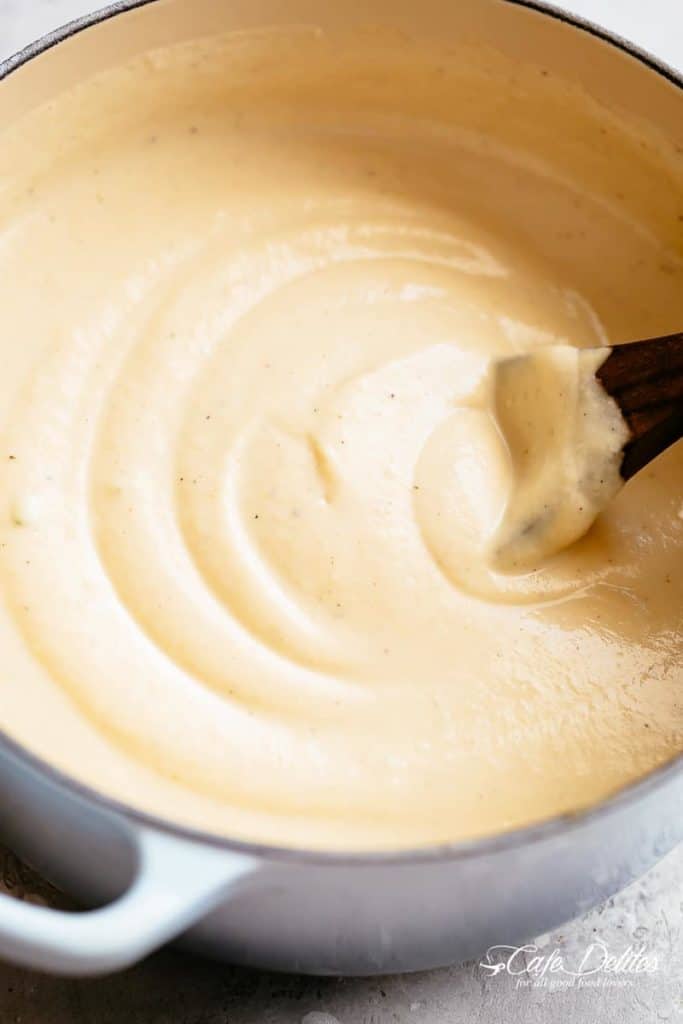 Thick and Creamy Cauliflower Soup is a delicious, healthy low carb substitute for potato soup! Blended with cream and served with crispy bacon, chives and shredded cheese, our Cauliflower Soup recipe is perfect for meal prep and reheats beautifully. Skip the bacon and make it vegetarian! | cafedelites.com