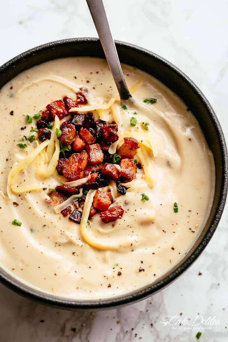 Thick and Creamy Cauliflower Soup is a delicious, healthy low carb substitute for potato soup! Blended with cream and served with crispy bacon, chives and shredded cheese, our Cauliflower Soup recipe is perfect for meal prep and reheats beautifully. | cafedelites.com